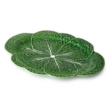 Green ceramic plate with leaf design on a white background