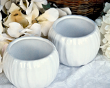 Pair of white ceramic candle holders  Add classic style to your home decor with these beautiful, ceramic candle holders. Whether paired with bohemian style decorations or traditional accents, these candle holders complement almost any home decor.   Materials: Ceramic  Dimensions: 3 3/4" x 3 3/4" in diameter overall  3" tall
