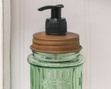 Green glass soap dispenser  This adorable embossed dispenser features with the word "Soap" for a vintage appearance. It has a rusty removable lid with a soap dispenser pump. It holds 12 ounces of liquid soap. This would look great in a bathroom or kitchen.  Materials: Glass, metal, plastic  Dimensions: 3" in diameter x 7 1/2" high