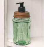 Green glass soap dispenser  This adorable embossed dispenser features with the word "Soap" for a vintage appearance. It has a rusty removable lid with a soap dispenser pump. It holds 12 ounces of liquid soap. This would look great in a bathroom or kitchen.  Materials: Glass, metal, plastic  Dimensions: 3" in diameter x 7 1/2" high
