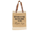 'Mom Life' tote bag 
The "Mom Life" bag celebrates the truths of the mom life with a little humor and functionality. A band of naturally colored cotton fabric accents this woven jute tote at the top and bottom. Silver metal studs attach brown faux leather handles and the tote reads "Nothing in this bag belongs to me - Mom life" in black block letters and script.
Materials:
Jute, fabric, faux leather, metal
Dimensions:
13" wide x 8" deep x 17" high 
26" long overall with handles