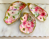 Drop your keys in one of these gorgeous trinket dishes that are made using recycled oyster shells. Each piece is meticulously handcrafted using oyster shells recycled from local restaurants in Washington, D.C. The shells are decoupaged with tissue paper and hand-painted gold.
This trinket dish makes for a great sorority gift or wedding gift.
This item is proudly made in the USA.
Materials:
Oyster shell, paint, tissue paper
Dimensions:
These oysters come in three sizes. 