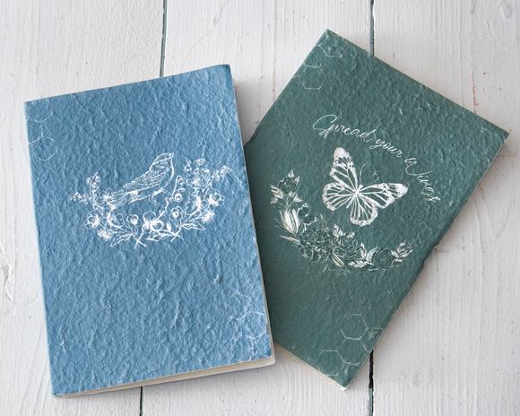 Our enchanting journals captivate a sense of artistry with their unbleached note paper and detailed paper mâché cover. Each book was fashioned with the idea that it can be a keepsake for the future, for generations to come. This is also a lovely gift for a recent high school graduate.<br><br>Your purchase includes two journals, one of each color -- blue and forest green. 