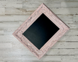 Make a statement at your spring wedding with this gorgeous framed chalkboard. Use this chalkboard to welcome guests, display candy buffet and dessert bar menu information, or provide a sign to designate the gift table. The possibilities are endless! Not only does this ornate chalkboard coordinate beautifully with other shabby chic and fairy tale reception supplies, it can also serve as a message board after the wedding.
This chalkboard is painted in layers of silver and light pink before being distressed t