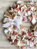 Each wreath is made using more than 3 yards of raw-cut 100% white cotton fabric strips that are between 6" and 10" long. The fabric strips are then tied onto a four-tier wire wreath form, which range in size from 16" in diameter to 20" in diameter depending on your preference. The wreath is topped with a simple handmade bow. <br>