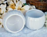 Pair of white ceramic candle holders  Add classic style to your home decor with these beautiful, ceramic candle holders. Whether paired with bohemian style decorations or traditional accents, these candle holders complement almost any home decor.   Materials: Ceramic  Dimensions: 3 3/4" x 3 3/4" in diameter overall  3" tall