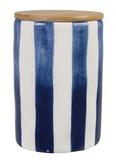 Cylindrical container with blue and white striped design and wooden lid on a white background