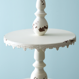 Ornate distressed creamy white tiered tray
Display desserts for a wedding or small items for your store on this feminine display stand. It features a loop to carry and is a large piece measuring almost 3 feet tall. It is made of metal and not food safe. It is recommended to use with dollies or liners.
Materials:
Metal
Dimensions:
14" diameter x 33" high