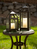 Make a statement with these eye-catching black lanterns. These lanterns are perfect for a modern farmhouse fireplace hearth or covered patio. Sleek and stylish, this decorative lantern features a thin iron frame in a black matte finish, encased with glass window panes. Place a pillar candle inside the lantern to instantly set the mood of any room.
Materials:
Metal, glass
Dimensions:
5 1/2" wide x 5 1/4" deep x 15 1/2" high