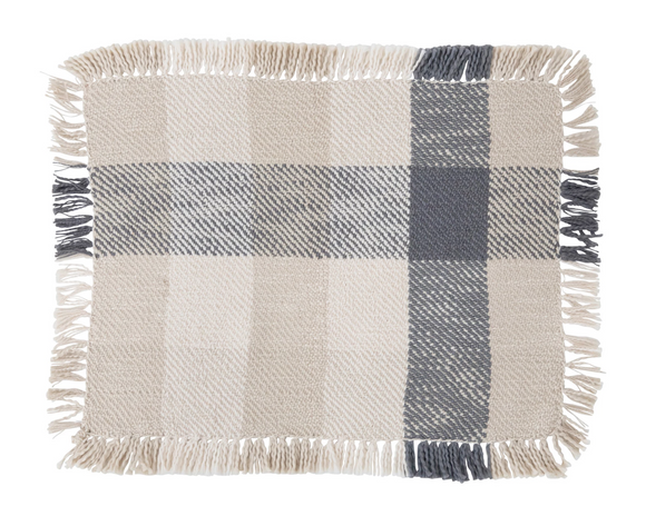 This multicolor woven cotton placemat features shades of blues, tans, and creams in a buffalo check design. The placemat is accent with fringe detailing along the sides. This item is perfect for a lake house or cabin. It is casual yet stylish.