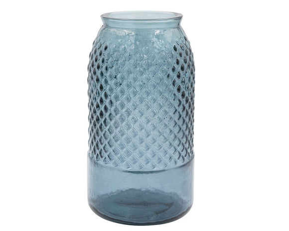 This embossed reclaimed glass jar is a beautiful piece that will enhance the home with its blue color. The jar is made of reclaimed glass, recycled from old bottles, jars, or windows. Reclaimed glass is eco-friendly and unique, as each piece has imperfections and variations. It has a simple and elegant design that can fit any French country, farmhouse, vintage, cottagecore, or coastal style decor.   Materials: Glass  Dimensions: 6