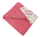 Folded red and white chevron pattern blanket with fringes on a white background
