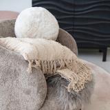 This sheepskin orb pillow is a beautiful and comfortable accessory for the home. It has a sheepskin cover that is warm and luxurious. The cover features a cream color that is neutral and elegant, and a round shape that is unique and fun. The pillow has a polyester insert fill that is soft and durable. Use this pillow as a backrest, a headrest, or a decorative accent. Place it on the sofa, bed, chair, or bench, and mix and match it with other pillows to create a cozy and stylish look.
