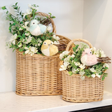 These baskets offer a charming accent for decorative displays. Made from woven willow with a natural light wood hue, the baskets feature a classic oval shape and single arched handle. They are perfect for displaying floral arrangements, decorative stakes, or other items.
Materials:
Willow
Dimensions:
Smaller basket -
8 1/4" wide x 4" deep x 10 1/2" high
Larger basket -
11 1/2" wide x 5 1/2" deep x 15 1/4" high