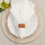 This wooden beaded napkin ring is a great way to elevate the look of your tabletop without overshadowing it. Casual, yet stylish these napkin rings bring texture to your place settings, as well as dimension. They're very easy to pair with a wide range of table linens and dinnerware.  These napkin rings are sold individually or in sets of four.  Materials: Wood, fabric   Dimensions: 1 1/2" in diameter