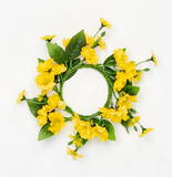 Floral wreath with yellow flowers and green leaves on a white background