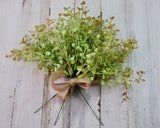 Add the finishing touch to a floral arrangement with this set of three greenery picks. Each one features shades of green artificial grass leaves. These picks are great for year-round use in vases, wreaths, and decorative pitchers. Each set comes with a removable jute ribbon that may be reused in your arrangements.