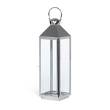 Tall glass lantern with metal handle on a white background