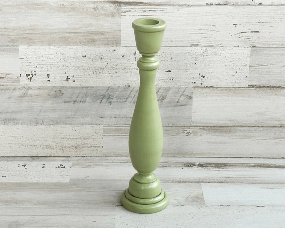 This hand-painted, wooden candle holder complements almost any home decor — country, rustic farmhouse, and even boho. Place several along a mantel to make a candlescape that won't block the view of your TV or use this candlestick to add a pop of color to an entryway. The possibilities are endless! <br><br>Sold individually, this wooden candlestick is painted in apple green and accented with a hand-rubbed java brown antiquing glaze to bring out its country style.