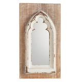 Distressed arched mirror on wood plank