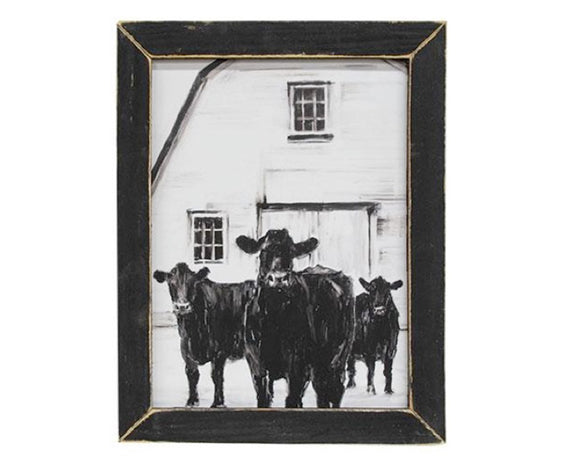 This wooden print features a white barn with three black cows, all in a charcoal drawing style. This print looks great with country decor and is held within a distressed black wooden frame. Display this sign hanging on a wall, using the keyhole hanger on the back of the frame, or lean it up on a tabletop or other flat surface. 