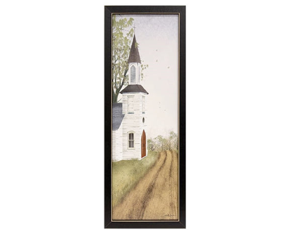 This piece is a decorative lightweight wooden print held inside of a black wooden frame. The print shows an old white church with a traditional steeple amidst a grassy pasture and tree grove with a dirt road. Display this print propped on a shelf or hanging on a wall using the saw-tooth hanger for a simple country accent in the home year-round. This item is proudly made in the USA.