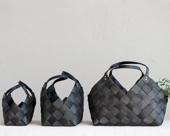 Set of 3 black woven baskets with handles  Store items in style with these gorgeous baskets. Each one features a woven wooden design finished in antique black. Use in a bathroom or bedroom for storing toiletries or even in a nursery to organize toys. The possibilities are endless!