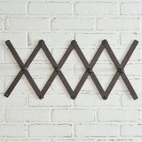 Classic black accordion wall hanging coat rack

Simple and adjustable, this black accordion coat rack has four hooks for hanging coats, scarves, and bags. To hang this up, it has a small hole on the top and bottom of each edge for a nail or screw.

Materials:
Wood, metal

Dimensions:
3" high x 37" wide&nbsp;