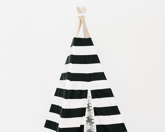 <br>This whimsical indoor-only play tent features soft pima cotton, bold black and white stripes, white pom-pom fringe, and ties with four wooden poplar rods to hold it up. It can easily folded up like an umbrella for storage. This would be a great gift for a child who loves to read and enjoys imaginative play.<br><br>This item is proudly made in the USA.