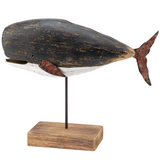 Wooden whale sculpture on a stand with a white background