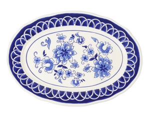 Elegant and sophisticated, this platter is lovingly painted by hand with every attention paid to detail and quality. While playing on classic sensibilities of blue and white pottery, it brings the trend into the modern era with its scalloped sturdy stoneware body and playful floral pattern.&nbsp;  Materials: Stoneware  Dimensions: 14 3/4" wide x 20 1/2" long overall