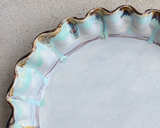 Multi-colored handmade stoneware pie plate

Bake your favorite dessert in this shallow pie plate. It is pretty enough to also double as a serving piece. This pie plate is handmade and hand-painted in Mississippi by artist Kim Ries. This item makes for a great wedding gift.&nbsp;

This item is proudly made in the USA.

Materials:
Stoneware

Dimensions:
10 1/2" diameter x 1 1/2" high

Care:
Oven and dishwasher safe