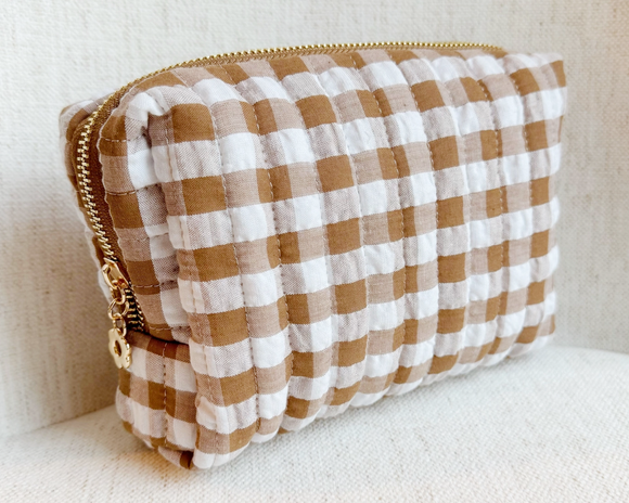 Brown gingham travel pouch

This cosmetic case boasts a vibrant gingham pattern that adds a pop of color to your travels. Its functional design ensures your cosmetics stay safe and organized on the go, making it the ultimate travel companion. a gold tone zipper with a daisy shape zipper pull completes the look.

Materials:
Cotton blend

Dimensions:
6