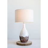 This cream color lamp with a rust and copper reactive glaze is reminiscent of a handmade vase. The light beige shades allow this lamp to fit in a wide range of room decors. <br><br>Materials:<br>Ceramic, linen, metal<br><br>Dimensions:<br>16" diameter x 28" high