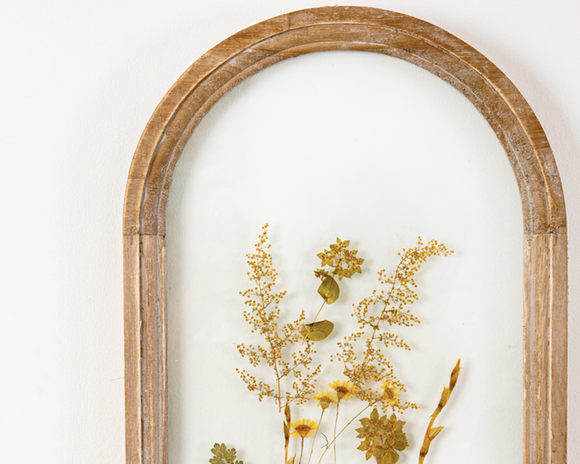 Made with real dried flowers and a wood frame, this botanical wall hanging is perfect for spring. Because these are real plants, each one is slightly different, but they are close in design. It comes with a sawtooth hanger for display.<br><br>Materials:<br>Wood, glass, hanging hardware<br><br>Dimensions:<br>11