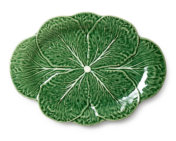 Green ceramic plate with leaf pattern on a white background