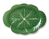 Green ceramic plate with leaf pattern on a white background