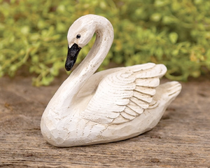  This decorative swan bird figurine is made of durable resin with a realistic carved and whittled texture with a natural wood grain. The swan has a distressed ivory finish and black painted beak and eyes. This swan brings a rustic touch to the home year-round, displaying freestanding on a riser, tray, shelf, or table.  