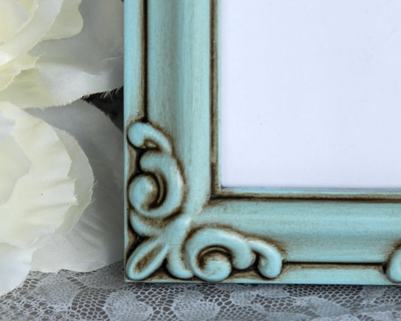 This decorative frame is painted in a light robin's egg blue and accented with a hand-rubbed java brown antiquing glaze designed to bring out its vintage-inspired style. It is finished with a clear matte wax sealer for durability.<br data-mce-fragment=