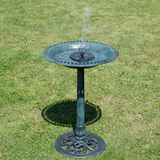Decorative garden fountain on a grassy lawn