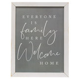 This sign features a distressed white frame with a gray background. It reads, "Everyone is family here - welcome home," in white text. It looks great in an entryway above a console table or a living room. This item is proudly made in the USA.