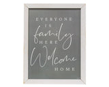 This sign features a distressed white frame with a gray background. It reads, "Everyone is family here - welcome home," in white text. It looks great in an entryway above a console table or a living room. This item is proudly made in the USA.