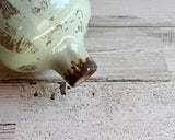 Light green miniature bud vase

This sweet miniature vase is the ideal choice for any area needing a little extra appeal. Its smooth glossy finish catches the eye. This beautiful piece of ceramic art makes a great gift.

Materials:
Ceramic

Dimensions:
3" diameter x 5" high

Care:
Clean with soft cloth