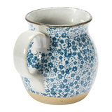 This beautiful pitcher features a hand-painted blue and white floral design accented by a light brown base. It is made of food-safe stoneware and a great size for creamer or salad dressing.&nbsp;  Materials: Stoneware  Dimensions: 4 3/4" wide x 6 1/4" high