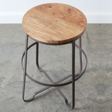 Bring a touch of industrial into your home with our small wood finished stool. The legs are made of rustic metal and finished with a wooden seat. These stools are counter height and would look great at a kitchen island. JaBella Designs