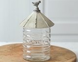 Large silo glass canister

The large vintage silo canister is created with a glass canister and a rustic metal lid with a bird. The front of the glass has a small coffee emblem. This item would pair nicely with other country-themed kitchenware.

This item is food safe.

Materials:
Glass, metal

Dimensions:
5" diameter glass cylinder
6" diameter x 11" high overall

Care:
Hand-wash only
