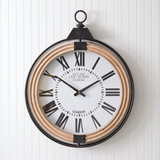 Large round light brown wood and black metal clock with white face in pocket watch style design