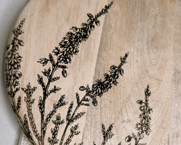 Wooden cutting board with engraved floral design