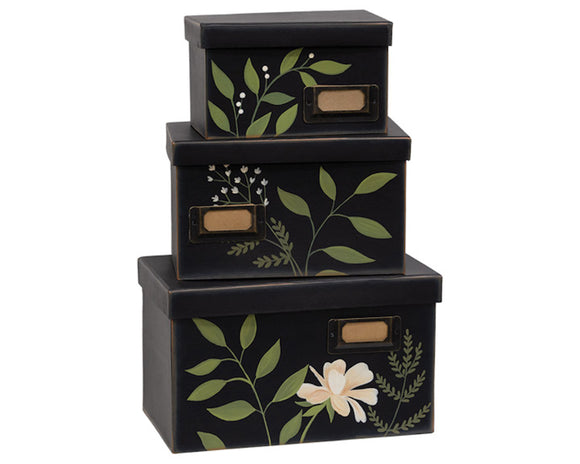 This three-piece box sex is decorated with hand-painted floral greenery and includes a vintage-style, metal label holder on each box. These boxes are great for storing paper goods, mementos, or even craft supplies. You could also use these as part of a gift set. The possibilities are endless! Materials:Paper board, metal