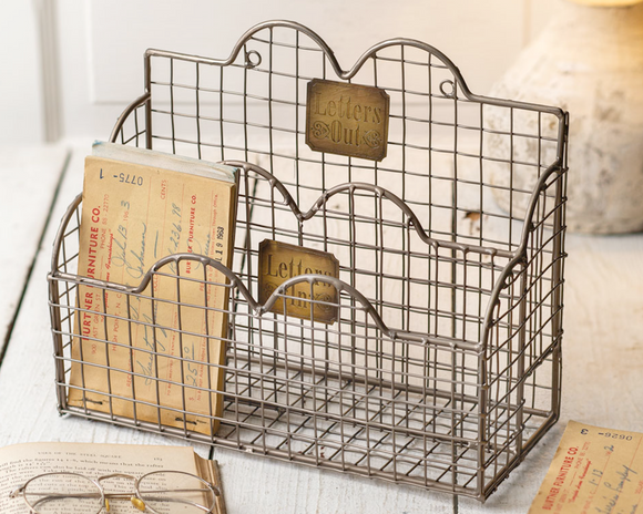 Antique-inspired mail caddy

Featuring an aged nickel finish and brass signs that read ''Letters In'' and ''Letters Out,'' this mail caddy has two compartments that fit books, letters and any standard size envelope. It comes with two rings on the back for hanging. 

Materials:
Metal

Dimensions:
8 1/2